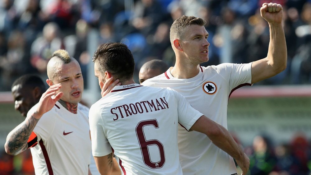 Edin Dzeko (right) celebrating with his Roma team-mates. Goal