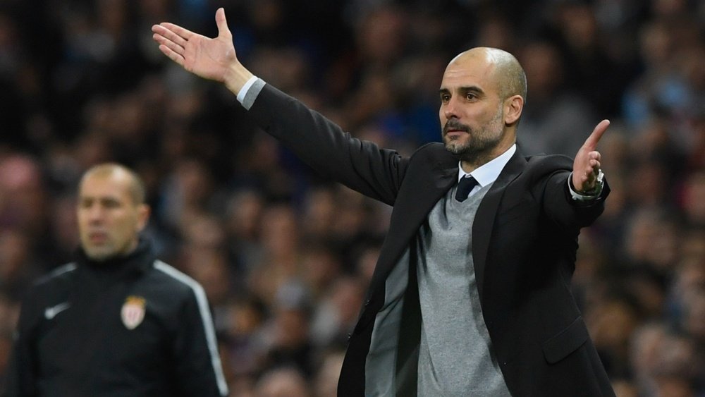 Guardiola holding up his hands. Goal