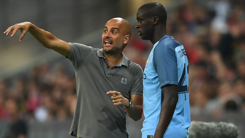 Guardiola (L) gives instructions to Toure. Goal