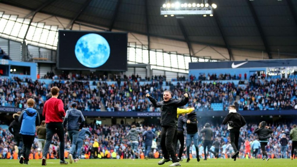 Fans invaded the pitch following City's win over Swansea. GOAL