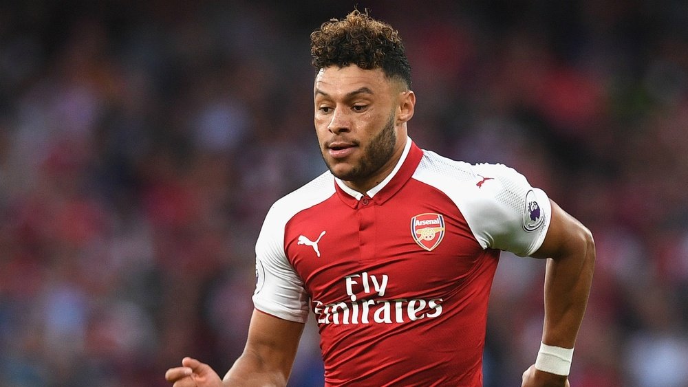 Wenger has urged Alex Oxlade-Chamberlain to commit to the club. GOAL
