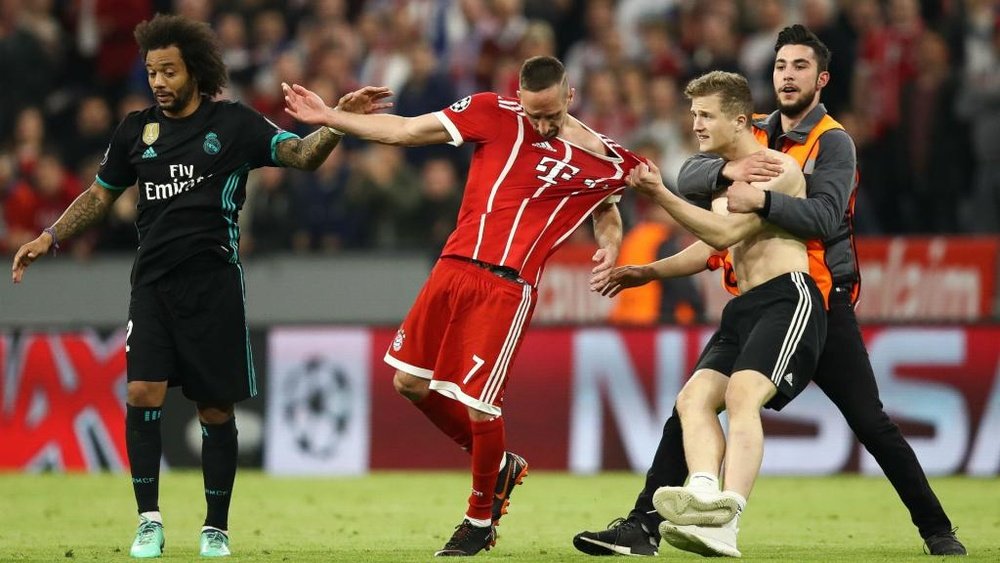 Fans invaded the pitch after Bayern's 2-1 loss to Real. GOAL