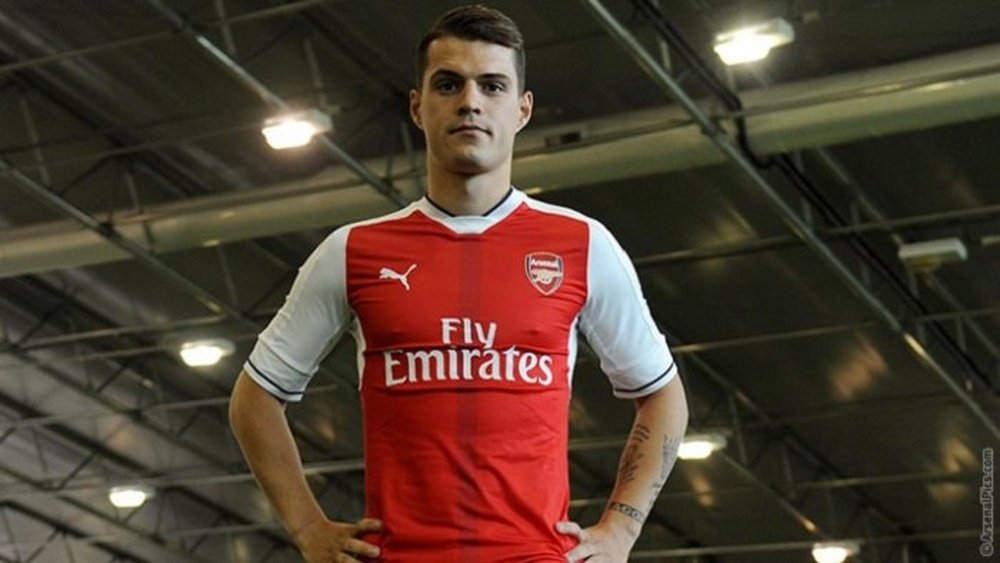 Granit Xhaka posing in his new Arsenal shirt. ArsenalFC