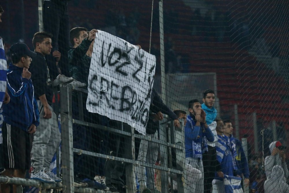 Greece fans hold up offensive banners. Twitter/BiHFootball