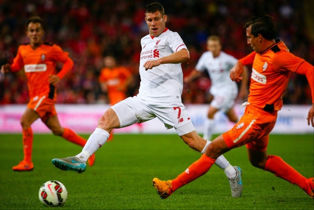 James Milner (L) of English Premier League side Liverpool fights for the ball with Shane Stefanutto of A-League side Brisbane Roar during a friendly at Suncorp Stadium in Brisbane on July 17, 2015.
