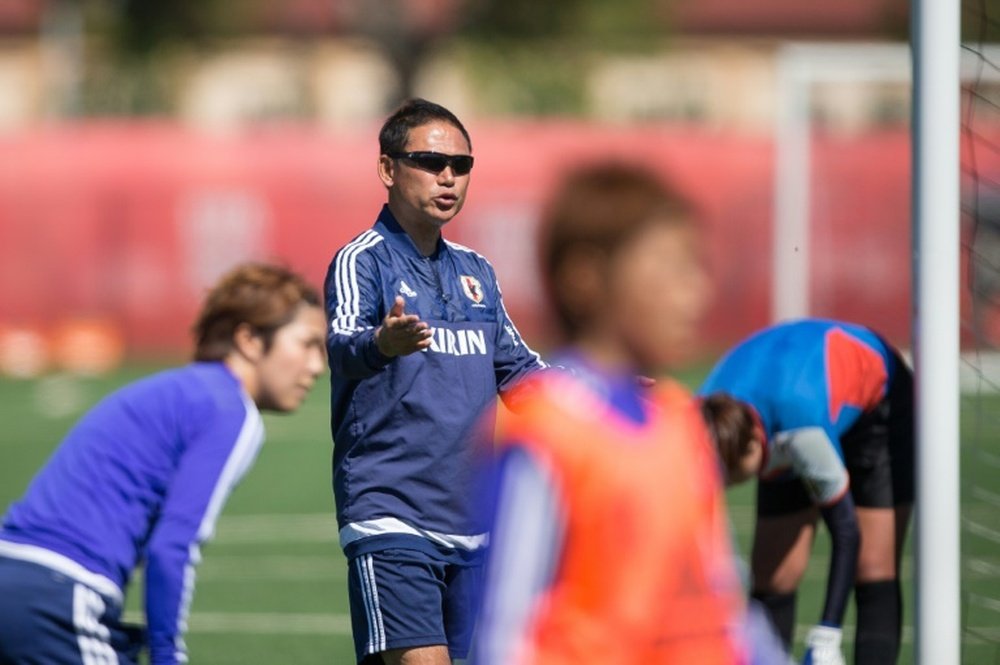 Japan head coach Norio Sasaki talks to his players during the team Women World Cup training session in Edmonton, Canada, on June 28, 2015