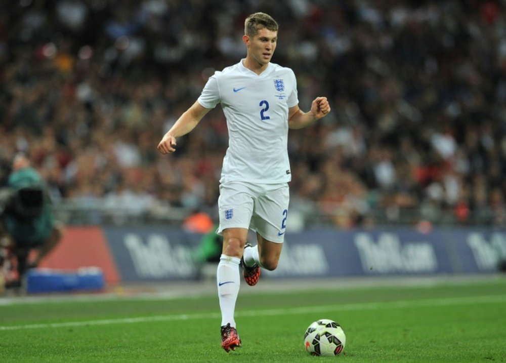 John Stones runs with the ball during the international friendly football match between England and Norway at Wembley Stadium in north London on September 3, 2014.