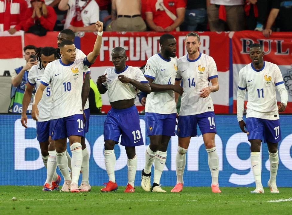 Mbappé celebra com seus companheiros o gol contra de Wöber. AFP