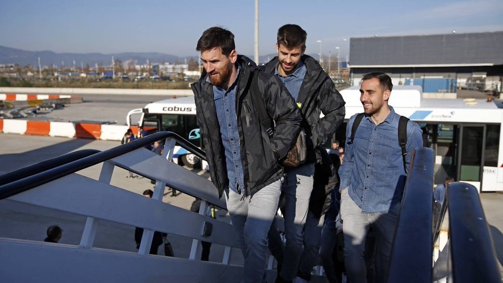 Leo Messi boarding a plane ahead of team-mate Gerard Piqué. FCBarcelona