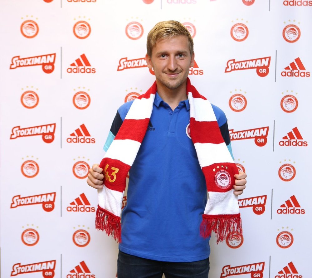 Marin poses with his new club's scarf. Olympiacos