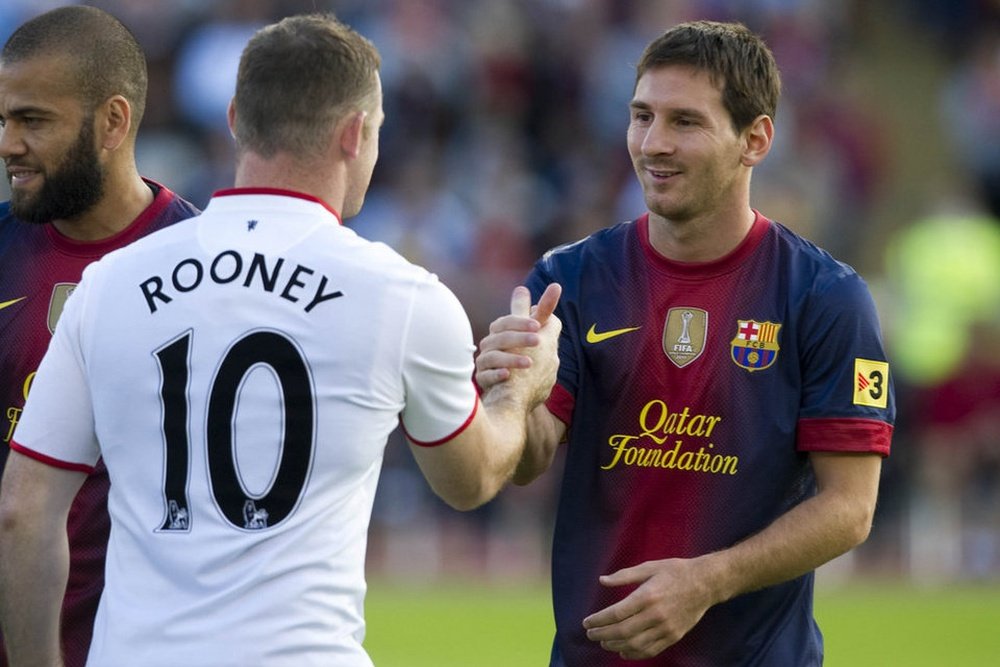 Messi y Rooney, en un partido. AFP