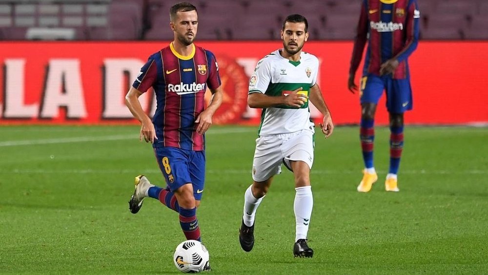 Miralem Pjanic (L) has returned to the Barcelona squad list. AFP