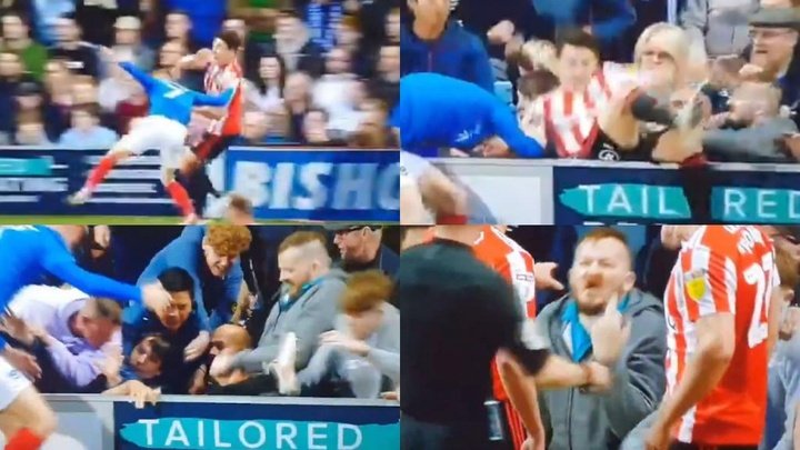 Portsmouth fan kicks opponent after falling into the crowd!
