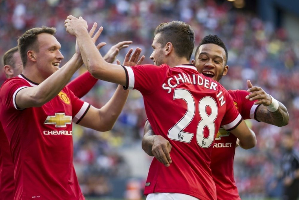 Morgan Schneiderlin (C) is congratulated by teammates Memphis Depay (R) and Phil Jones after he scored against Club America in their International Champions Cup match on July 17,2015 in Seattle, Washington.