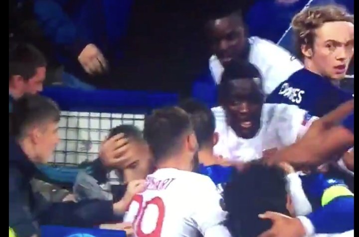 Everton fan carrying child attempts to punch opposition player