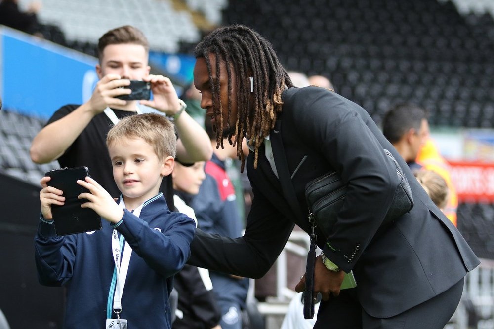Sanches with a young fan before the game against Newcastle. Swansea