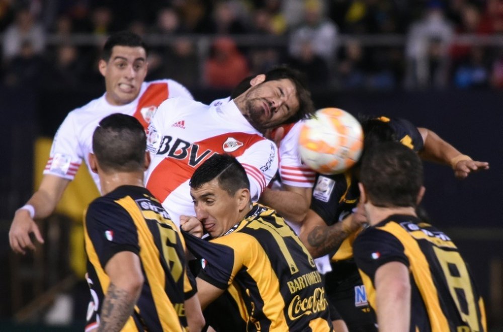 River Plate Rodrigo Mora (C top) heads the ball in the middle of a scramble with Guarani during their Libertadores Cup semi-final second leg match at the Defensores del Chaco stadium in Asuncion, on July 21, 2015