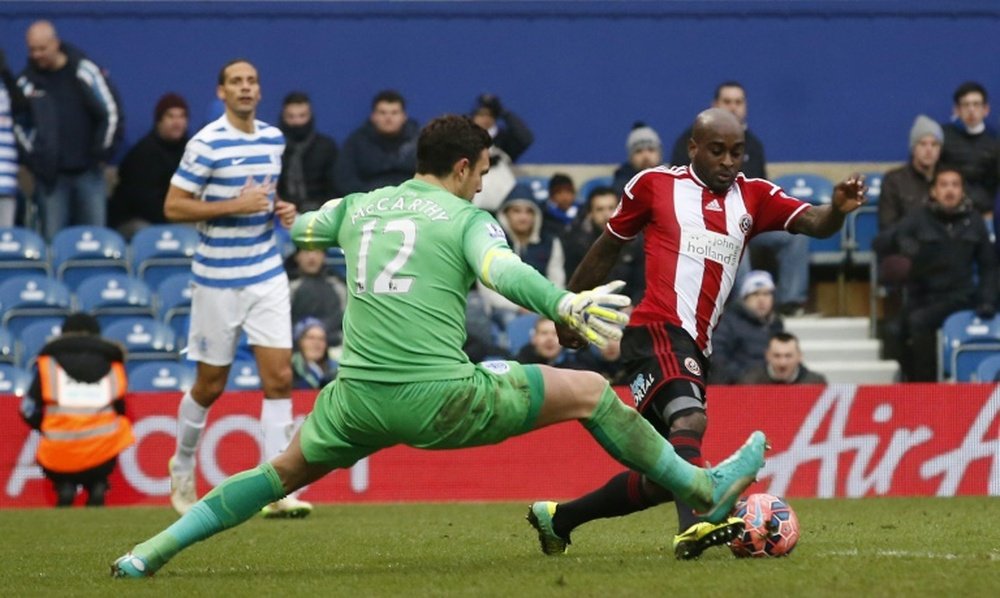 Sheffield United Jamal Campbell-Ryce (R) rounds Queens Park Rangers English goalkeeper Alex McCarthy (C) during the English FA Cup third round football match at Loftus Road Stadium in London, on January 4, 2015