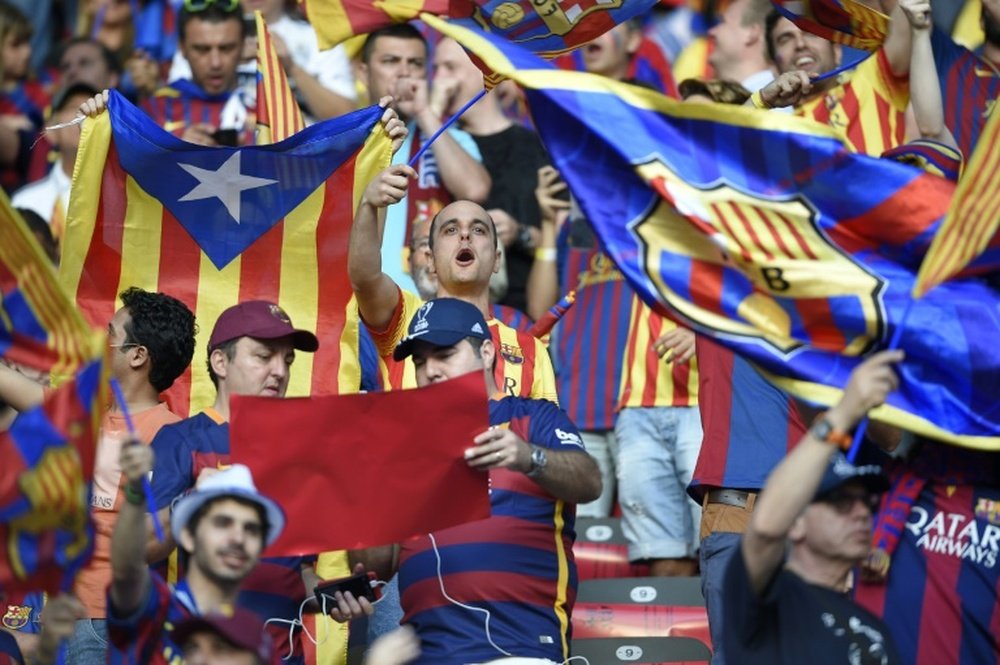 Supporters of FC Barcelona cheer while waving Barcelona and Catalan flags prior to the UEFA Champions League Final football match between Juventus and FC Barcelona at the Olympic Stadium in Berlin on June 6, 2015
