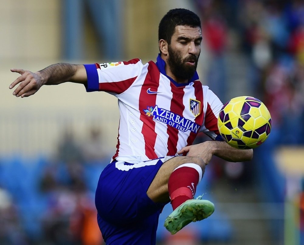 Turkish international Arda Turan, seen here in action with Atletico Madrid in November 2014, is heading for Barcelona on a five-year deal for a fee that could reach 41 million euros