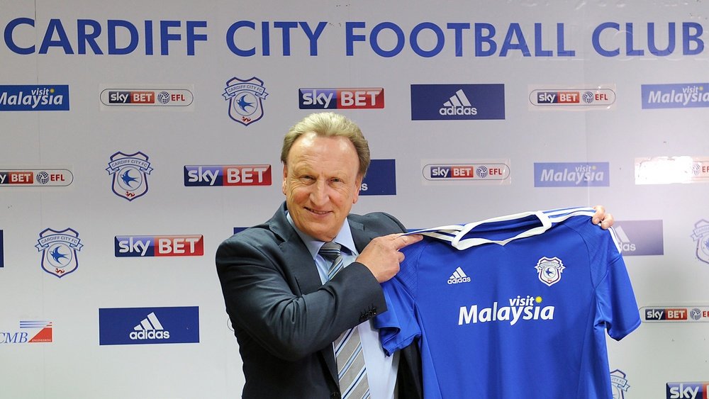 Warnock poses with the Cardiff shirt. CardiffCityFC