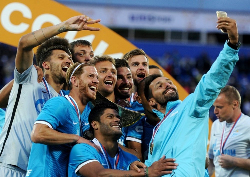 Zenit St. Petersburg players pose for a selfie with the trophy after winning their Russian Super Cup match against Lokomotiv Moscow at the Petrovsky stadium in St. Petersburg on July 12, 2015