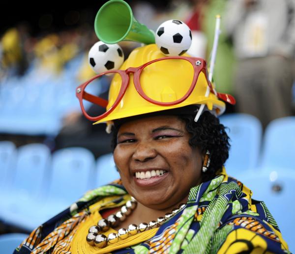 ventilador, con un sombrero gracioso, espera a que el inicio de la Copa del Mundo 2010 de fútbol segunda vuelta entre Japón y Paraguay en el estadio Loftus Versfeld de Pretoria