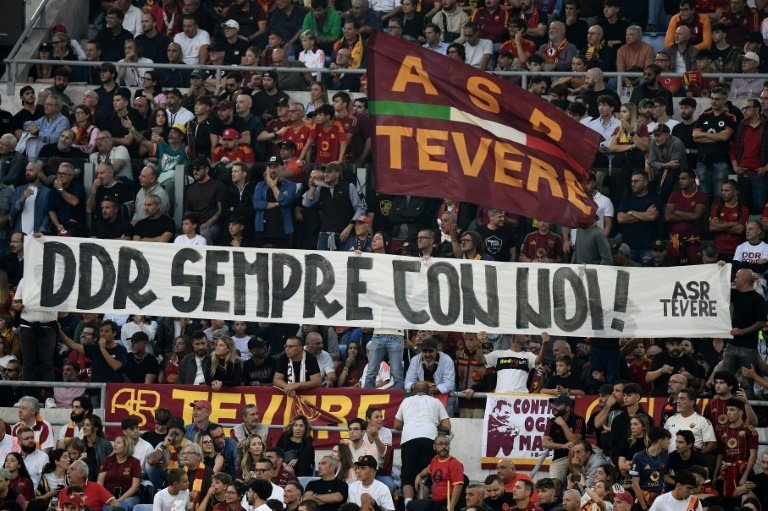 Roma supporters hold a banner reading Daniele De Rossi always with us. AFP