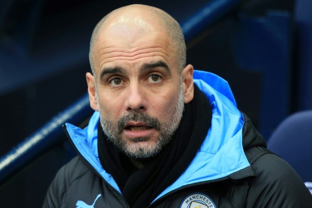Pep Guardiola reassured fans that he'll stay at Man C. AFP