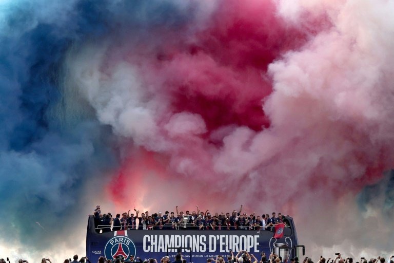An estimated 100,000 fans packed the Champs-Elysees on Sunday to cheer the Paris Saint-Germain players and staff as they paraded the Champions League trophy in the French capital.