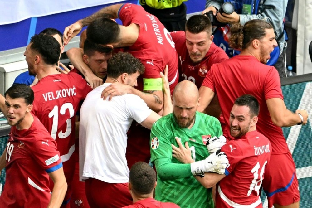 Jovic is mobbed after grabbing a late equaliser for Serbia against Slovenia. AFP