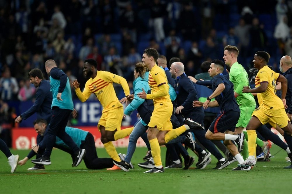 Barca players run for safety. AFP