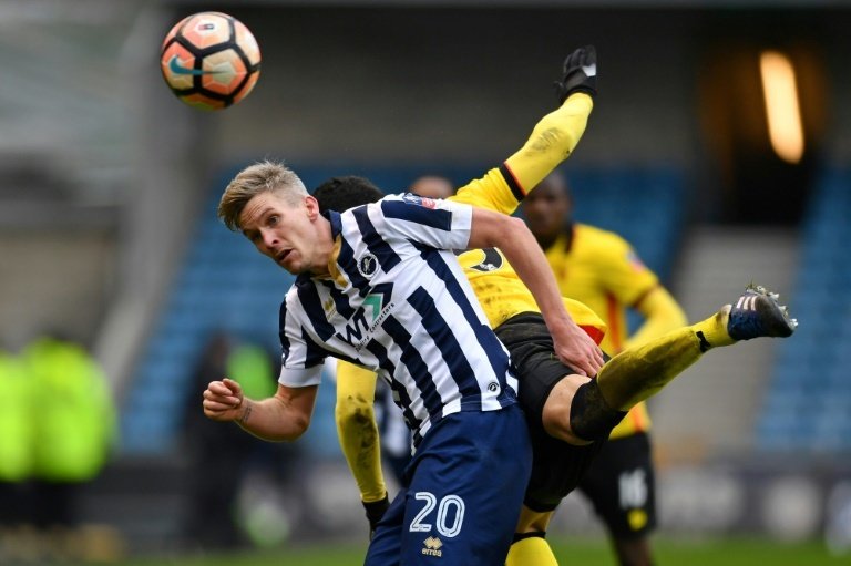 Millwall's Steve Morison (left) views with Watford's Miguel Britos. AFP