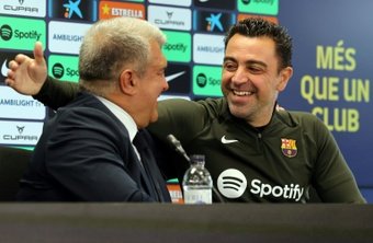 Laporta (L) and coach Xavi (R) spoke on Thursday about the latters decision to stay on. AFP