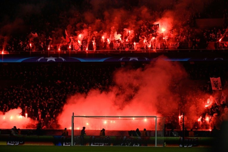 The 'Boulogne' stand of the Parc des Princes was illuminated by flares against Madrid. AFP