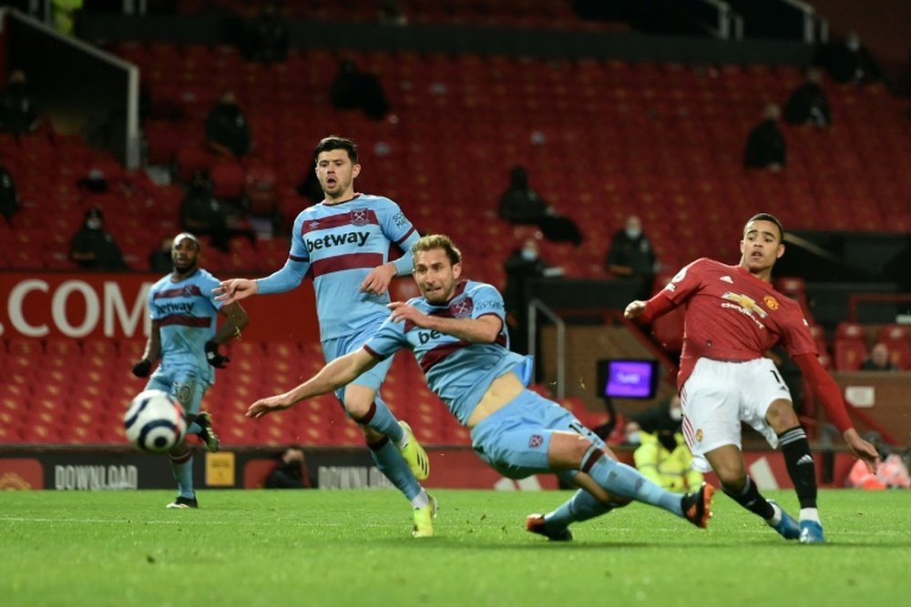 Man Utd moved back into second after an own goal by Craig Dawson (C). AFP