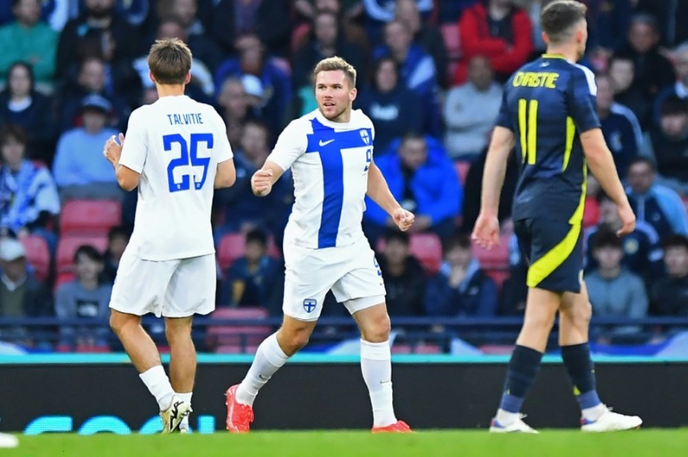 Finland striker Benjamin Kallman (C) scored against Scotland. AFP
