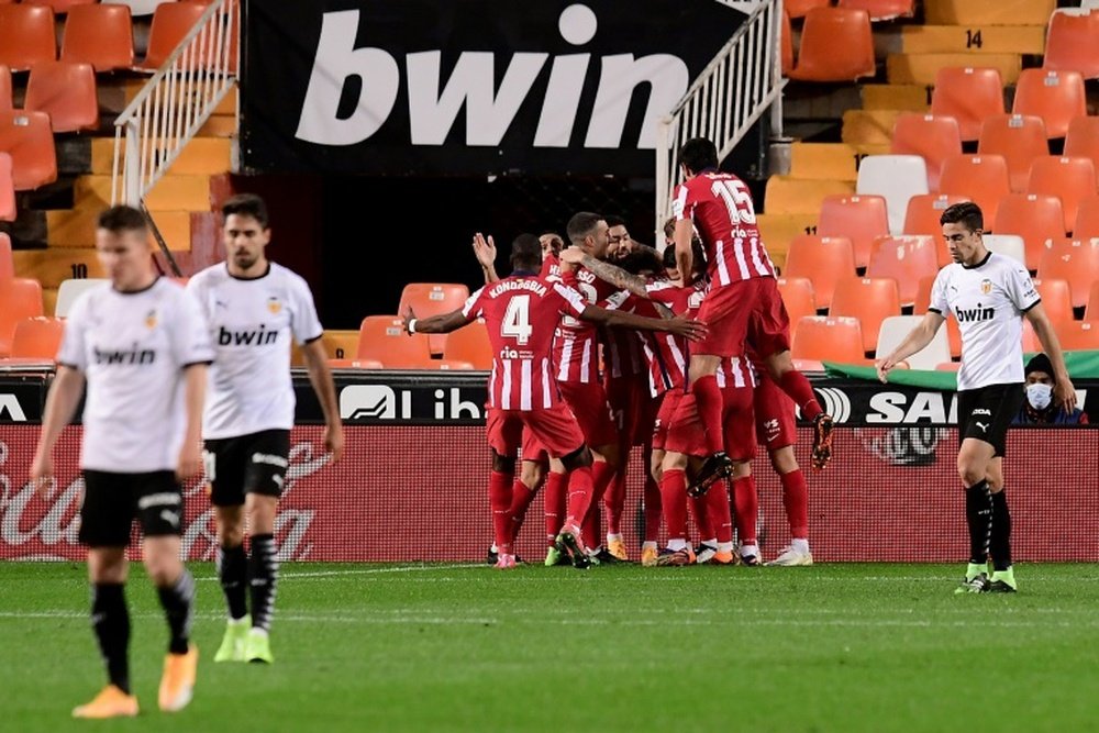 Atletico Madrid beat Valencia in La Liga thanks to an own goal. AFP