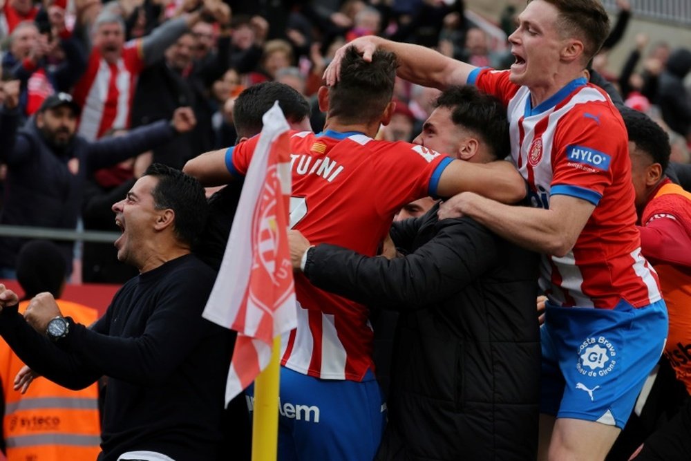 Girona take the top spot ahead of Real Madrid's game against Granada. AFP