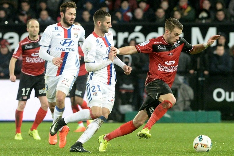 Guingamp's Lucas Deaux (right) vies with Lyon's Maxime Gonalons. AFP