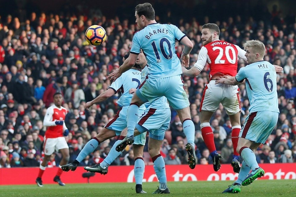 Arsenals Shkodran Mustafi (2nd R) jumps to head the opening goal of their English Premier League match against Burnley, at the Emirates Stadium in London, on January 22, 2017