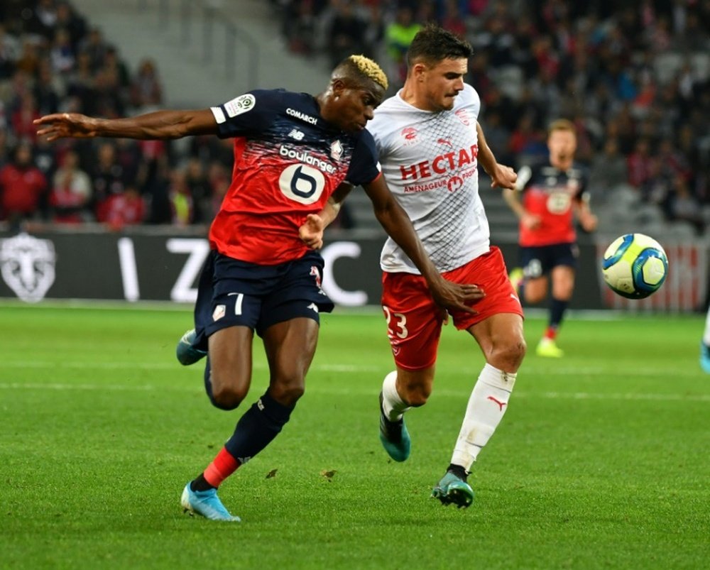 Nigeria forward Victor Osimhen claimed a late point for Lille . AFP