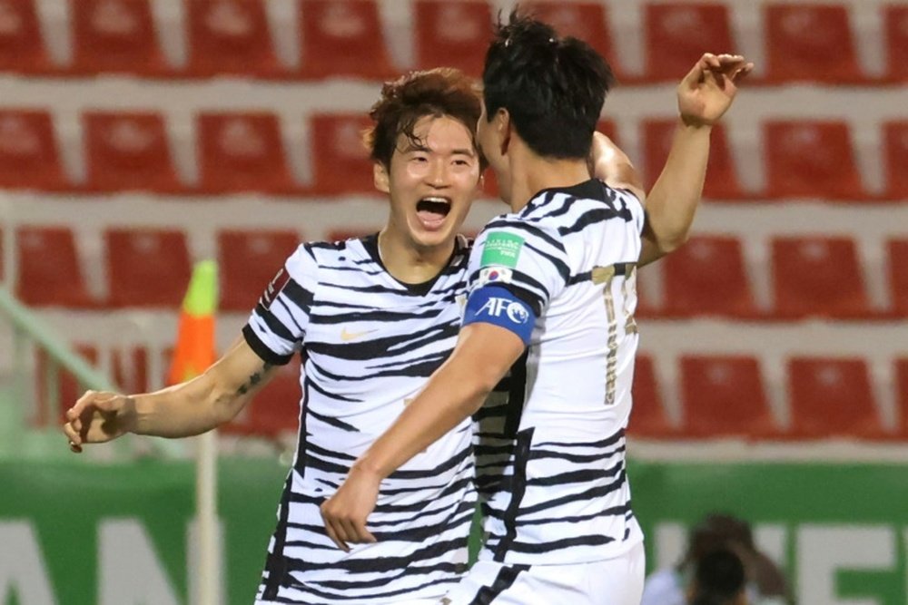 Kim Jin-su accepts congratulations after scoring South Koreas opener against Syria. AFP