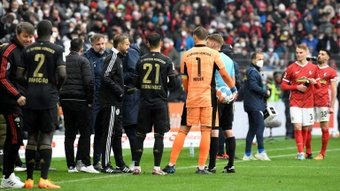 Referee Christian Dingert speaks to the Bayern Munich and Freiburg benches on Saturday. AFP