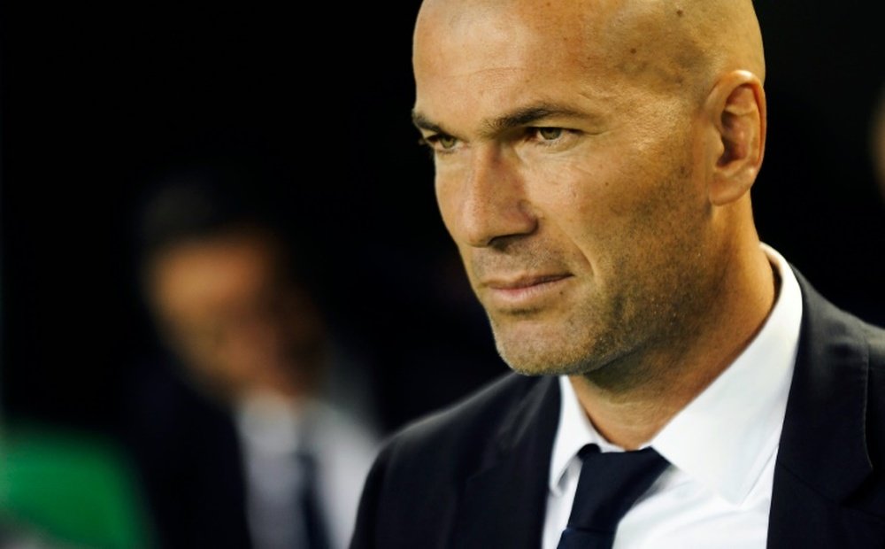 Real Madrids French coach Zinedine Zidane waits before the Spanish league football match Real Betis vs Real Madrid CF at the Benito Villamarin stadium in Sevilla on October 15, 2016