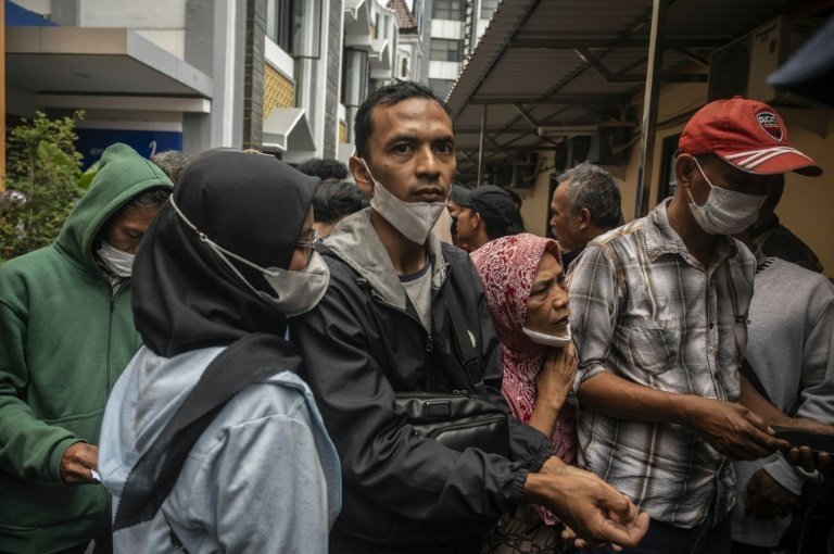 Relatives, survivors grieve at Indonesian hospital after stadium stampede. AFP