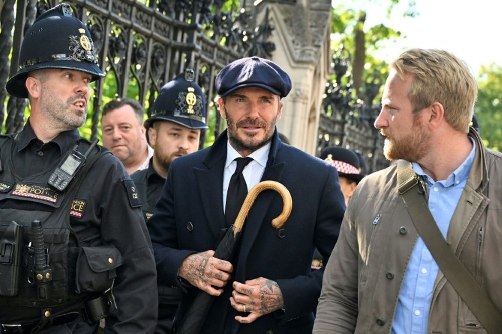 Beckham queues through the night to see queen's coffin. AFP