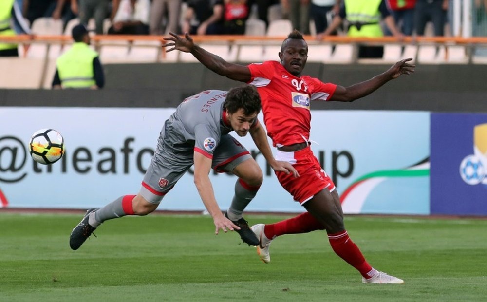 Perspolis Godwin Mensha (right) in action in Tehran. AFP
