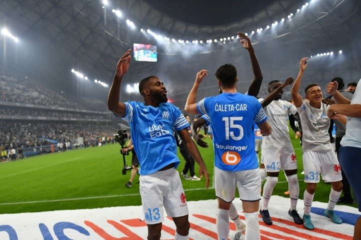 Marseille players celebrate securing UCL qualification on the last day of the Ligue 1 season. AFP