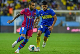 Dani Alves vies for the ball with Boca Junior's Ramirez in the inaugural Maradona Cup friendly. AFP